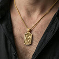 Load image into Gallery viewer, Gold plated Saint Christopher pendant necklace worn on neck, premium lifestyle composition, rectangular devotional medal centerpiece