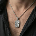 Load image into Gallery viewer, Polished silver St Christopher medal necklace worn on neck, close lifestyle crop, clear saint relief and engraved text details