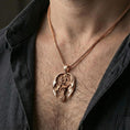 Load image into Gallery viewer, Rose gold plated dragon cross pendant worn on neck, detailed scale texture and skull accent, clean lifestyle framing with dark shirt contrast