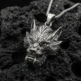 Load image into Gallery viewer, Oxidized sterling silver Chinese dragon head pendant on volcanic rock, detailed mythical dragon face necklace, macro close-up