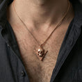 Load image into Gallery viewer, Rose gold plated Absolute’s talisman skull necklace worn on neck, BG3 inspired pendant, elegant lifestyle photo