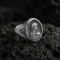 Load image into Gallery viewer, Oxidized sterling silver Virgin Mary signet ring on volcanic rock, oval Marian relief, macro jewelry photo