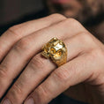 Load image into Gallery viewer, Gold plated skull ring with cross worn on finger, gothic Christian skull jewelry, biker gift ring, lifestyle close-up