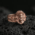 Load image into Gallery viewer, Rose gold plated Jesus Christ ring on volcanic stone, Christ face relief ring, Christian signet style ring macro shot
