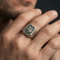 Load image into Gallery viewer, Oxidized sterling silver cross heart ring worn on finger, sacred heart flame relief, cross side detail close-up