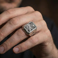 Load image into Gallery viewer, Oxidized sterling silver Saint Francis ring worn on finger, saint relief detail, cross shoulder engraving close-up