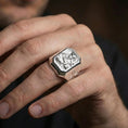 Load image into Gallery viewer, Polished silver Saint Francis signet ring worn on finger, Christian faith ring, halo engraving detail