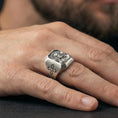 Load image into Gallery viewer, Oxidized sterling silver Jesus Christ ring worn on finger, sacred portrait relief, cross shoulder detail close-up