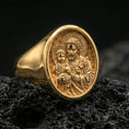 Load image into Gallery viewer, Gold plated St Joseph signet ring on volcanic rock, Christian devotion jewelry closeup