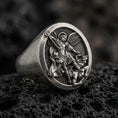Load image into Gallery viewer, Oxidized 925 sterling silver St. Michael signet ring on volcanic rock, archangel defeating evil relief, Christian protection jewelry