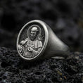 Load image into Gallery viewer, Oxidized sterling silver St Francis signet ring on volcanic rock, detailed saint relief portrait