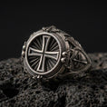 Load image into Gallery viewer, Oxidized 925 sterling silver round cross signet ring on volcanic rock, sunburst background, ornate side filigree