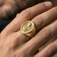 Load image into Gallery viewer, Gold plated Holy Eucharist signet ring worn on finger, chalice and host symbol ring with wheat and vine details, statement style
