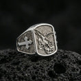Load image into Gallery viewer, Polished silver Archangel Michael signet ring on porous volcanic stone, detailed battle relief and clean bezel shine