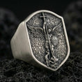 Load image into Gallery viewer, Oxidized 925 sterling silver Saint Michael ring on volcanic rock, shield signet with Archangel defeating serpent relief