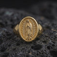 Load image into Gallery viewer, Gold plated Our Lady of Guadalupe signet ring displayed on volcanic rock as faith jewelry