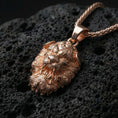 Load image into Gallery viewer, Rose gold plated Chinese Fu Dog pendant necklace presented on volcanic rock surface with refined oriental guardian style