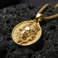 Load image into Gallery viewer, Gold plated Medusa pendant necklace showcased on volcanic rock as a symbol of power, protection, and transformation