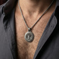 Load image into Gallery viewer, Oxidized Yggdrasil tree of life pendant necklace worn on male model as a Norse spiritual talisman