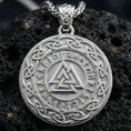 Load image into Gallery viewer, Polished silver Valknut Norse rune pendant displayed on volcanic stone background with sharp geometric relief and knotwork