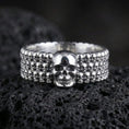 Load image into Gallery viewer, Polished silver faceted wedding band displayed on volcanic stone highlighting crisp angular reflections and modern minimalist cut