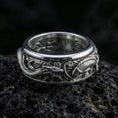 Load image into Gallery viewer, Polished silver dragon carp spinner ring displayed on volcanic stone highlighting detailed scales waves and smooth fidget rotation