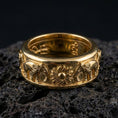 Load image into Gallery viewer, Gold plated elephant spinner ring showcased on volcanic rock with symbolic sun emblem, anxiety fidget band style and premium engraved texture