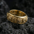 Load image into Gallery viewer, Gold plated spinning roses wedding band presented on volcanic rock with luxe botanical detailing and premium romantic statement aesthetic