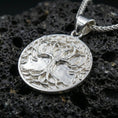 Load image into Gallery viewer, Polished silver Tree of Life necklace on porous volcanic stone, detailed Yggdrasil medallion with bail and braided chain
