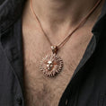 Load image into Gallery viewer, Rose gold plated Helios pendant necklace worn on neck, radiant sunburst rays around Helios face
