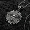Load image into Gallery viewer, Oxidized 925 sterling silver Helios sun pendant on volcanic rock, radiant sunburst rays with face relief and braided chain