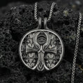 Load image into Gallery viewer, Oxidized 925 sterling silver ankh pendant on volcanic rock, Eye of Providence medallion with Egyptian symbolism and ornate background pattern