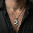 Load image into Gallery viewer, Polished silver Medusa skull necklace worn on neck, serpent pendant with sculpted face relief and bold statement style