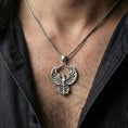 Load image into Gallery viewer, Polished silver phoenix necklace worn on neck, rising bird pendant with refined feather layers and modern styling