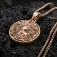 Load image into Gallery viewer, Rose gold plated medusa coin necklace on dark volcanic stone, medusa medallion pendant with premium relief detail