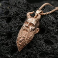 Load image into Gallery viewer, Rose gold plated Mimir head necklace on dark volcanic stone, Viking mythology pendant with horned head and long beard