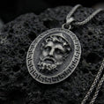Load image into Gallery viewer, Oxidized sterling silver Medusa face pendant on volcanic rock, Greek key border medallion, macro studio shot