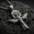 Load image into Gallery viewer, Oxidized sterling silver Egyptian winged ankh cross pendant on volcanic rock, engraved hieroglyph details, macro studio shot