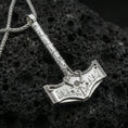 Load image into Gallery viewer, Polished silver Thor hammer necklace on volcanic rock, sharp etched rune symbols and clean hammered edges, close-up lighting