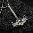 Load image into Gallery viewer, Oxidized sterling silver Mjolnir Thor hammer pendant on volcanic rock, engraved Nordic runes and knotwork, macro studio shot