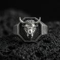 Load image into Gallery viewer, Oxidized sterling silver bull head signet ring on volcanic rock, octagonal face with high-relief horns, macro studio shot