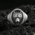 Load image into Gallery viewer, Oxidized sterling silver bear head signet ring on volcanic rock, detailed fur texture and open-mouth relief, macro studio shot