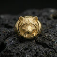 Load image into Gallery viewer, Gold plated raccoon head signet ring on volcanic rock, premium studio scene, nature-inspired animal motif with bold relief