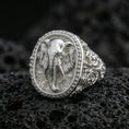 Load image into Gallery viewer, Polished silver elephant signet ring on volcanic rock, raised elephant head relief with beaded frame and scrollwork details, close-up