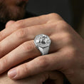 Load image into Gallery viewer, Polished silver lioness signet ring worn on finger, lifestyle hand shot, sculpted lioness portrait signet with textured background detail