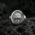 Load image into Gallery viewer, Polished silver tiger signet ring on volcanic rock, oval bezel with detailed tiger portrait and clean smooth rim, close-up jewelry shot