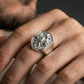 Load image into Gallery viewer, Polished silver shield octopus signet ring worn on finger, lifestyle hand shot highlighting crisp crest outline and high-relief tentacle details