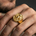 Load image into Gallery viewer, Gold plated shield octopus signet ring worn on finger, premium lifestyle wear photo featuring bold nautical octopus emblem and solid signet profile