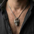 Load image into Gallery viewer, Oxidized Hermes pendant necklace worn on neck, lifestyle close-up on dark outfit, winged helmet pendant centered