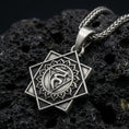 Load image into Gallery viewer, Oxidized Throat Chakra (Vishuddha) pendant on textured volcanic rock, macro close-up, geometric chakra symbol detail, premium studio lighting